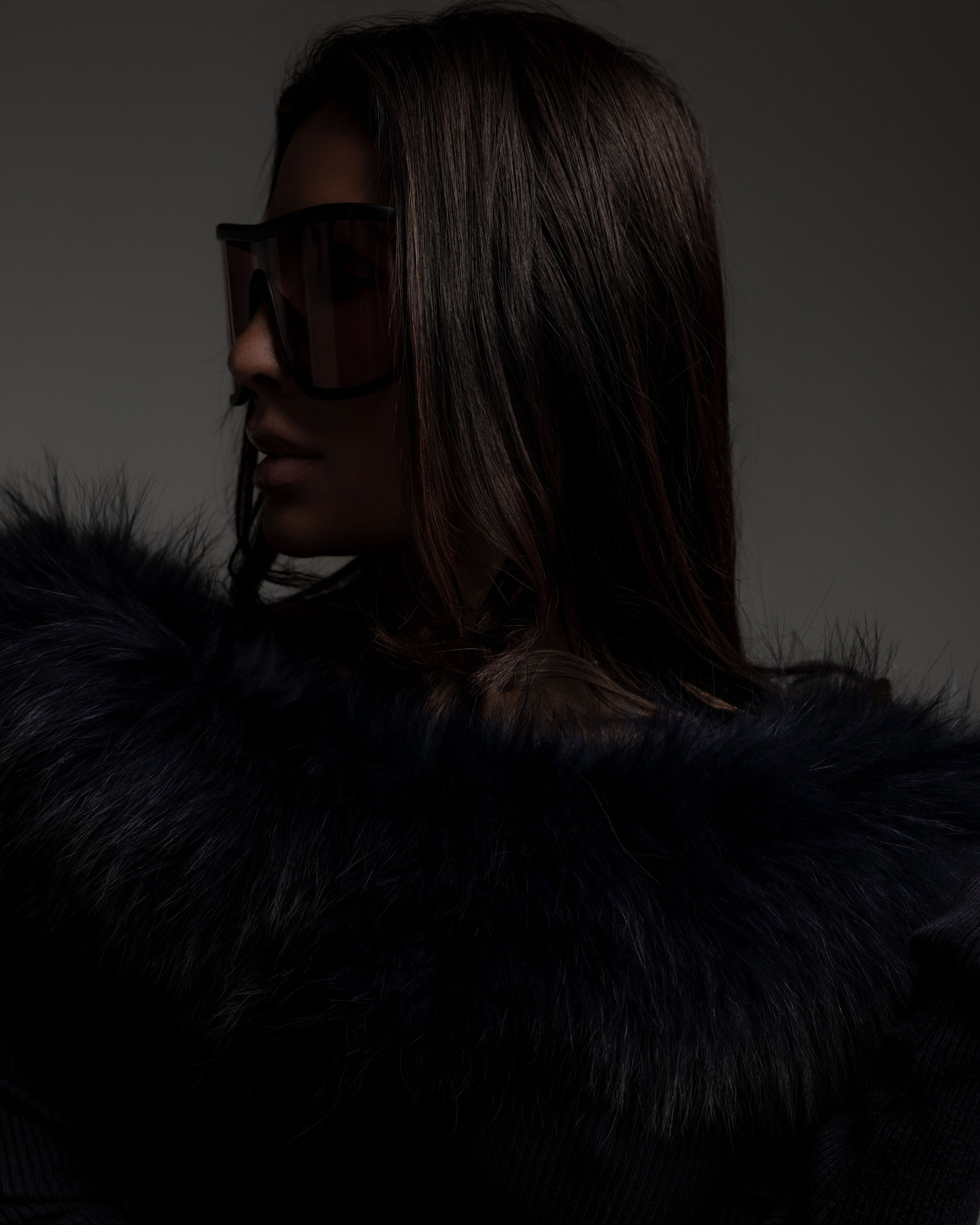 Shana Mak in the studio, fur collar, in shadow